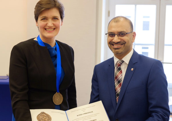 Katja Urbatsch und Universitätspräsident der JLU Prof. Dr. Joybrato Mukherjee lächeln in die Kamera